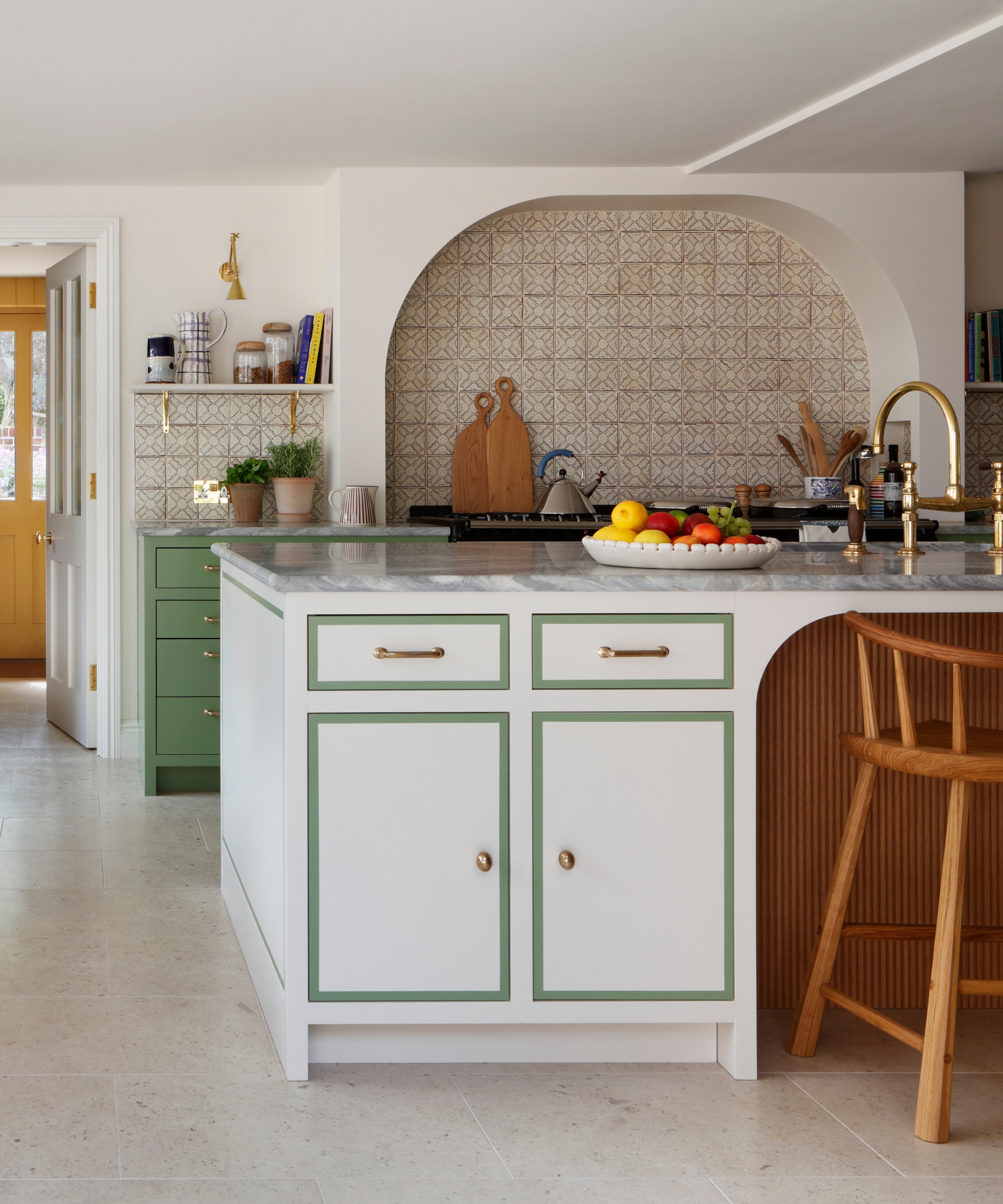 A while and green kitchen with colorful cabinet borders