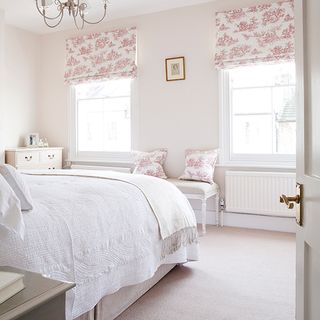white bedroom with red and white floral blinds