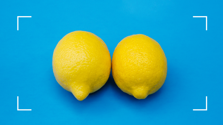 two lemons on blue background representing how to check for breast cancer