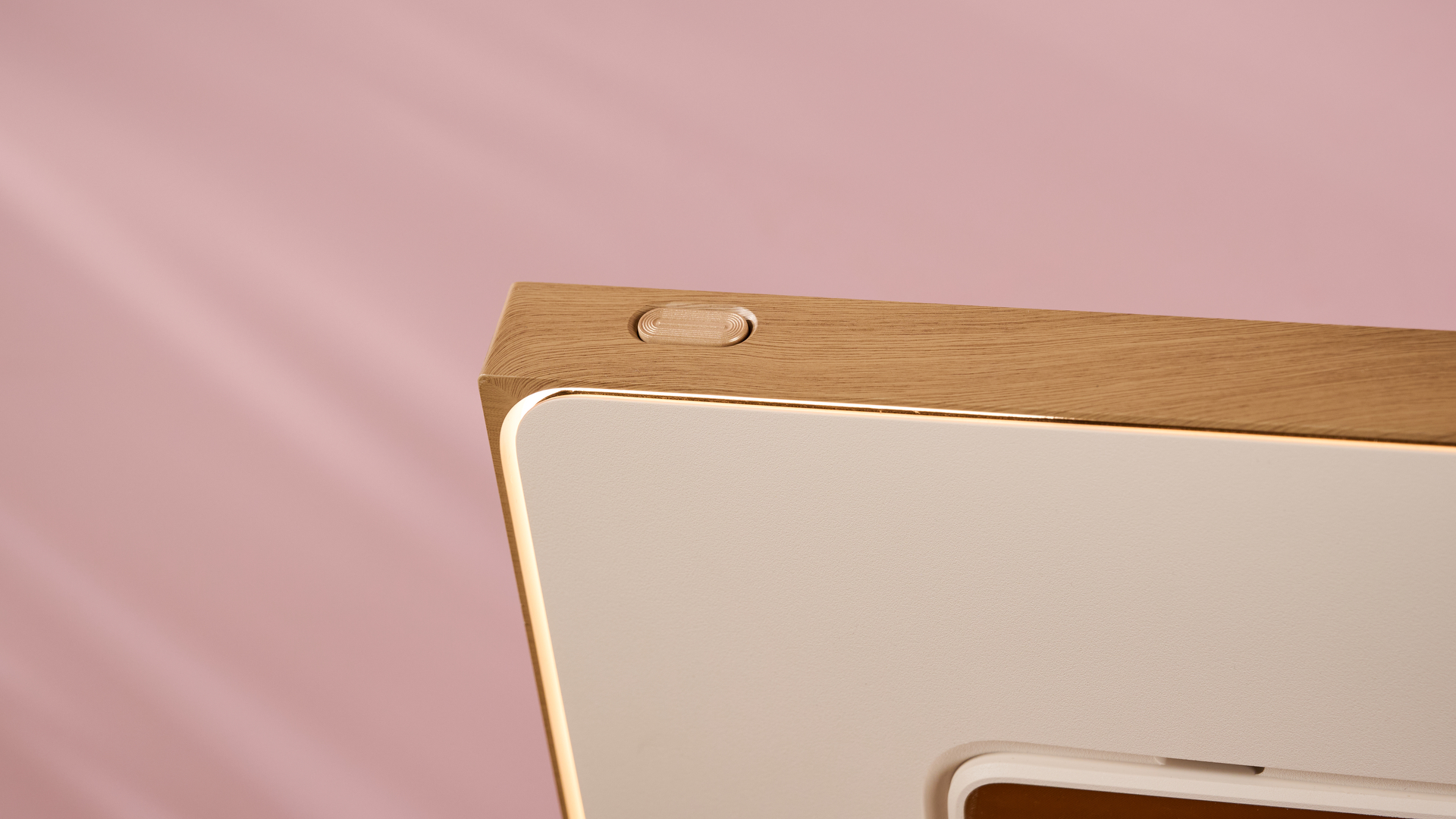 A closeup of the rear of the Pexar Starlight 15.6-inch, focusing on its power button and rear light.