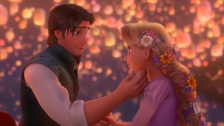 Flynn holding Rapunzel's face as lanters fly around them. 