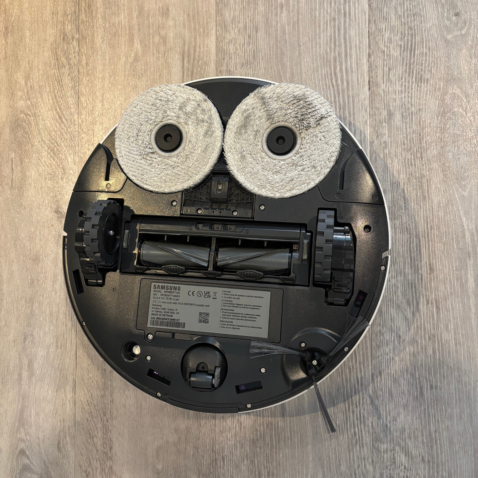 Bottom view of the Samsung Jet Bot Combo showing mop pads, wheels and rolling brush