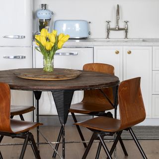 kitchen diner with round wood table and dining chairs