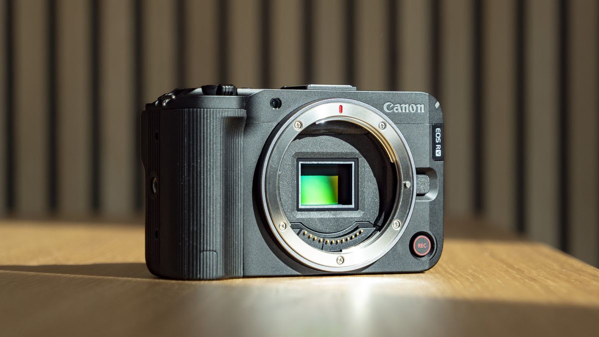 Canon EOS R50 V on a wooden table, no lens