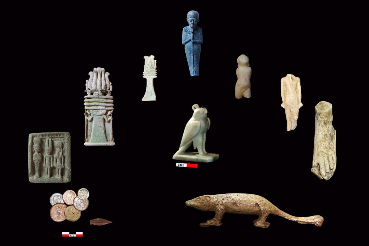 An array of granite statues of people and animals in neutral and blue colors