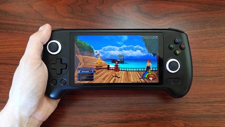 Hand holding Anbernic RG556 handheld with Kingdom Hearts gameplay on screen.