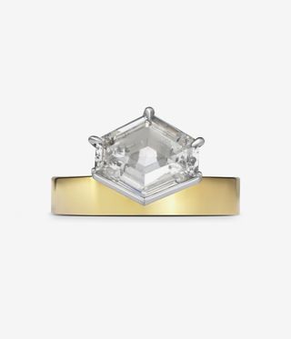 Aelia ring with a gold ring band and hexagon cut diamond.