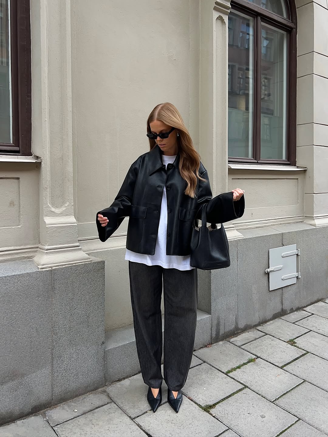 Woman wearing collared leather jacket trend fall 2025.