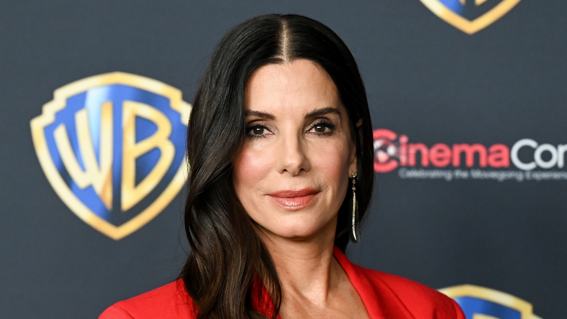 Sandra Bullock is pictured wearing a red blazer and a rosy lip gloss at the Warner Bros. Pictures Photocall during CinemaCon 2026, the official convention of Cinema United, at The Dolby Colosseum at Caesars Palace on April 14, 2026 in Las Vegas, Nevada.