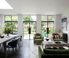 Green sofa, armchairs and dining chairs, white rug