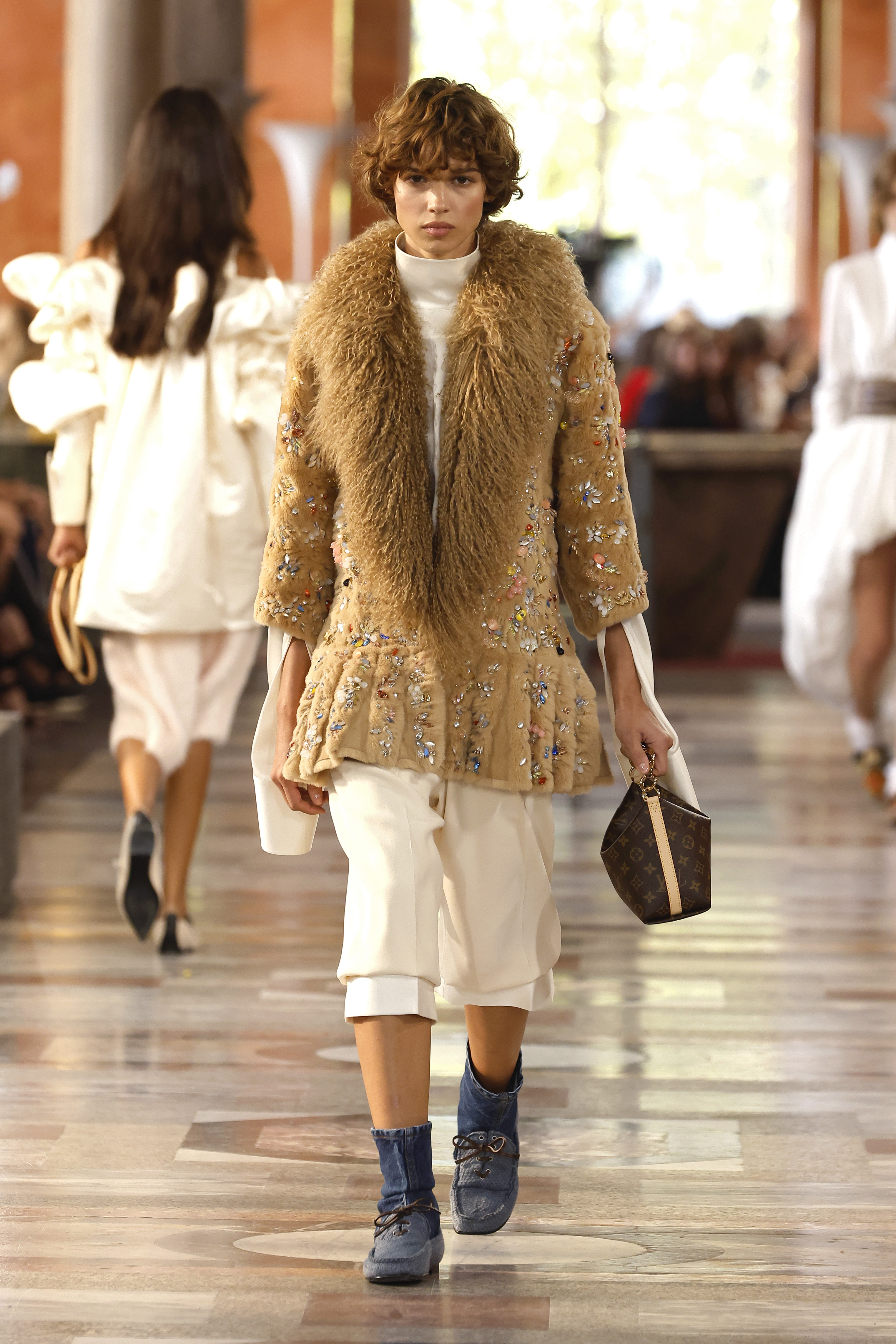 An image of the Louis Vuitton spring/summer 2026 runway featuring denim heelless boots.