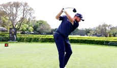 Shane Lowry hits a tee shot with a driver on the 15th hole