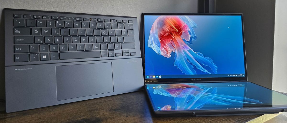 The Asus Zenbook Duo laptop photographed on a wooden desk.