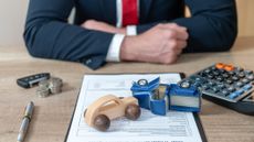 two model cars collide on a legal document on the desk of a lawyer