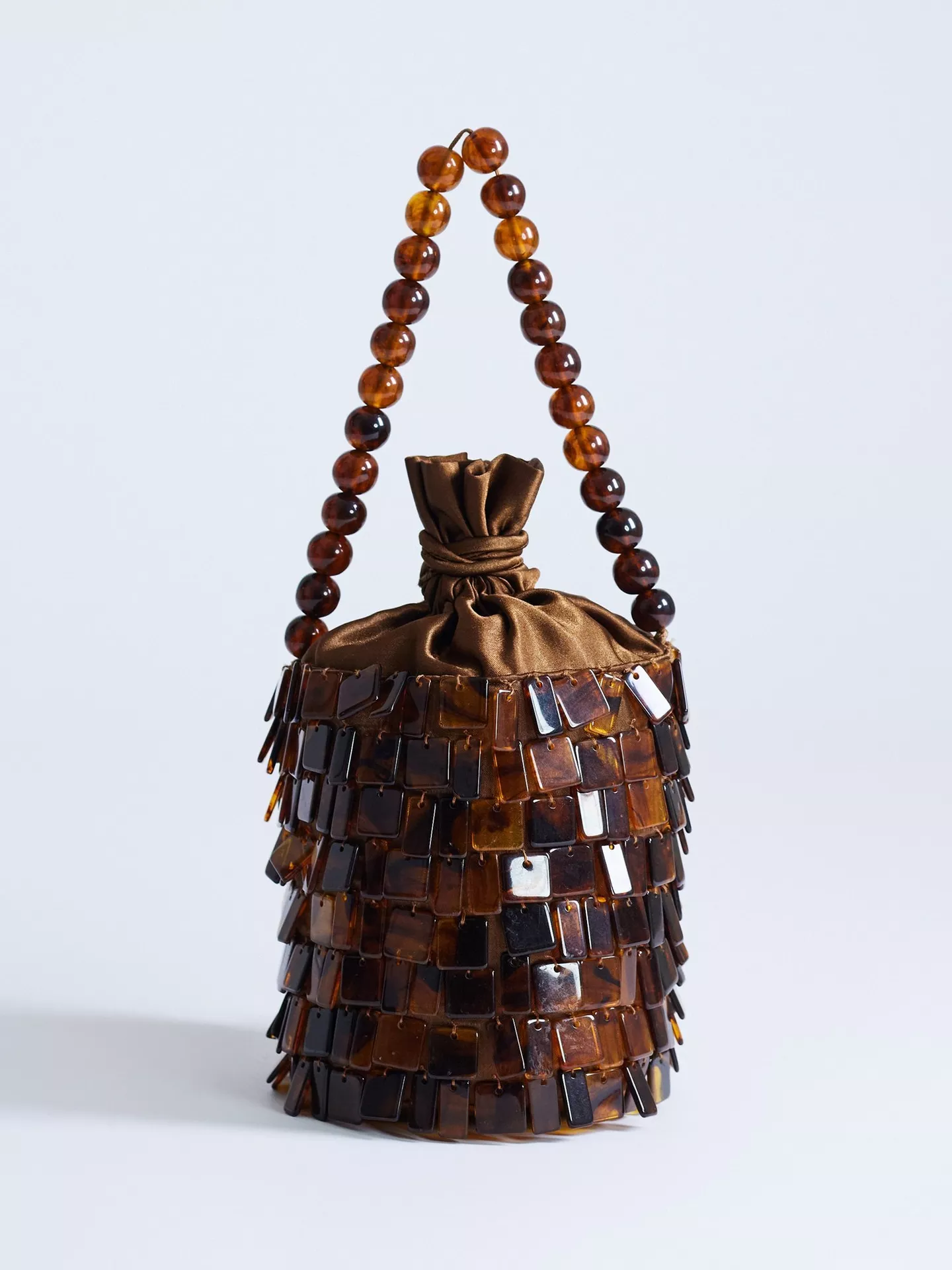 A brown beaded Topshop bucket bag.