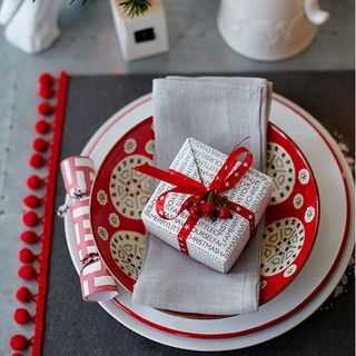Christmas place setting with gift wrapped box