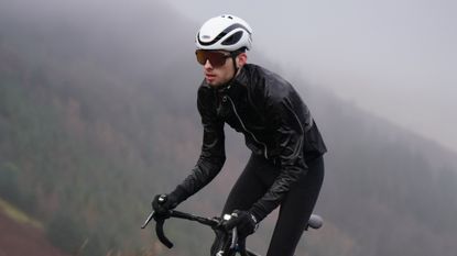 Image shows a rider wearing a waterproof cycling jacket.