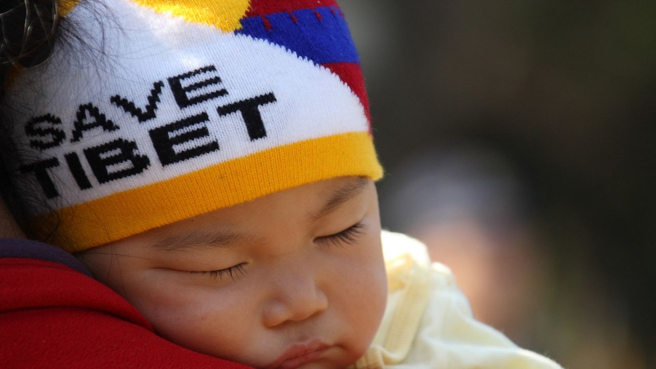 A sleeping child at a protest for Tibet