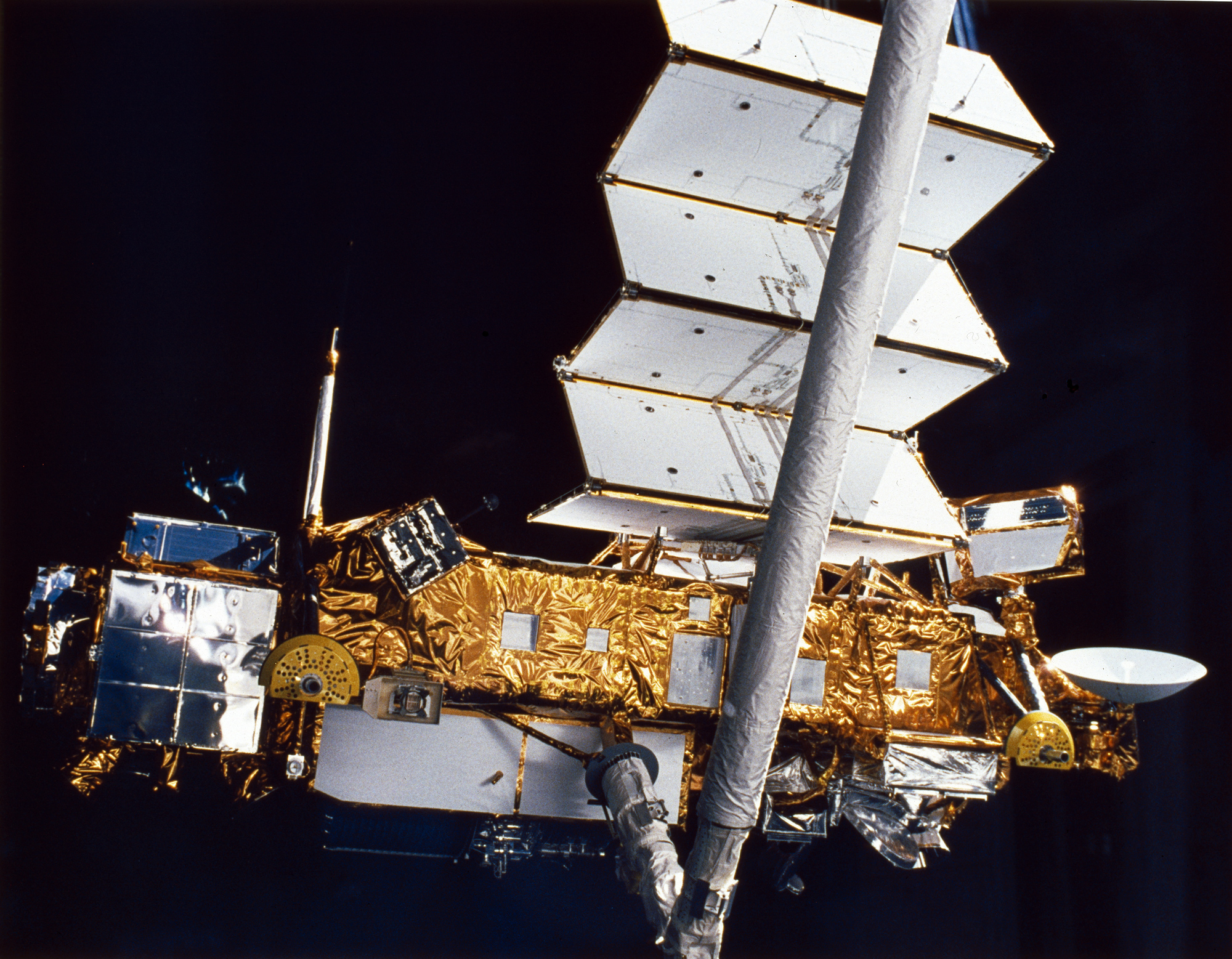 The Upper Atmosphere Research Satellite hangs in the grasp of the Remote Manipulator System against the blackness of space during deployment from Space Shuttle Discovery, September 1991.