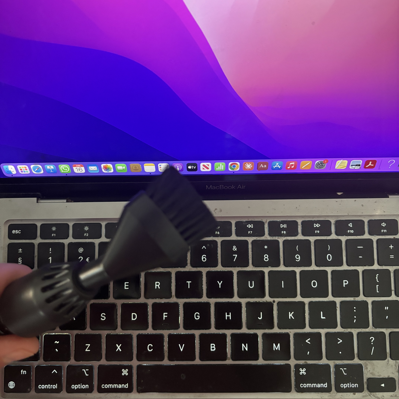 Shark PowerBoost Cordless Handheld Vacuum brush attachment to clean laptop