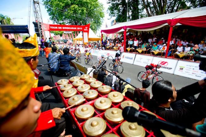 Riders cross the finish line at Padang circuit
