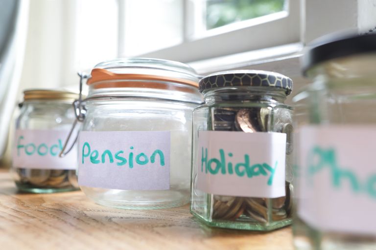 Jars containing small change labelled food, pensions, holiday