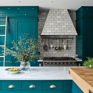 Turquoise kitchen with grey tiled hood