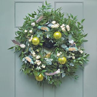 Christmas wreath on turqoise front door