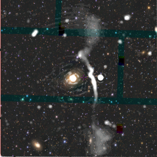 A giant radio galaxy with plumes of electrons stretching nearly 5 million light years from top to bottom of the image. These plumes had never been seen before the EMU Pilot Survey, even though the galaxy IC5063 (the bright blob in the centre) is a very well-studied galaxy. The radio emission (white) is superimposed on an optical imge (coloured) from the dark energy survey.