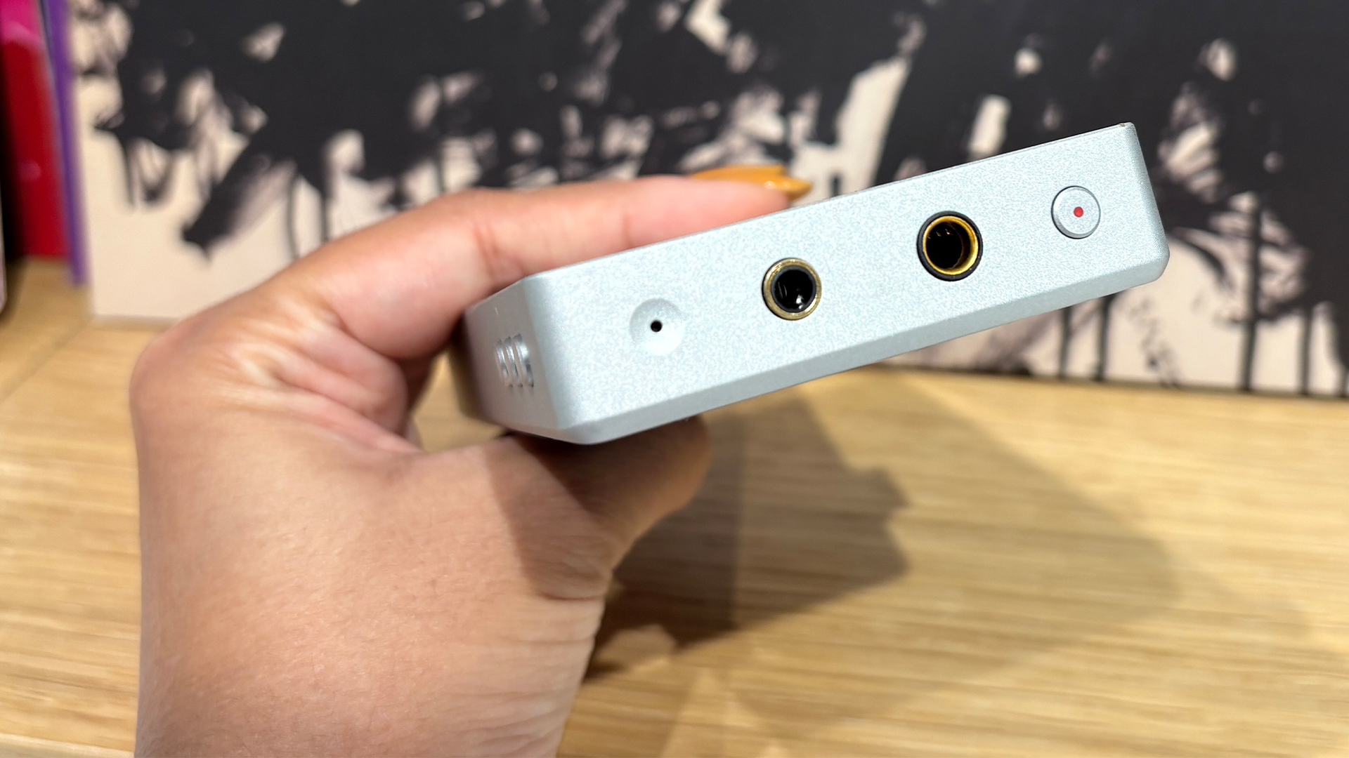 Astell &amp;amp; Kern PD5 portable music player held in hand showing headphone sockets