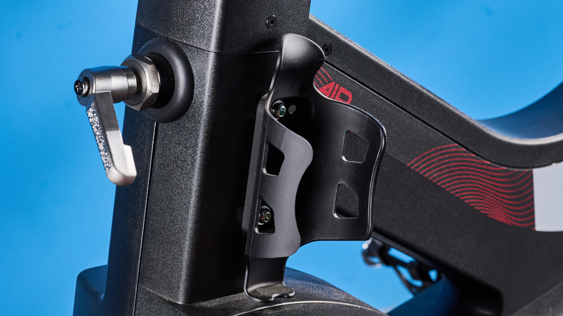 the wattbike air with a black and white front wheel, adjustable seat, and phone holder with app compatibility