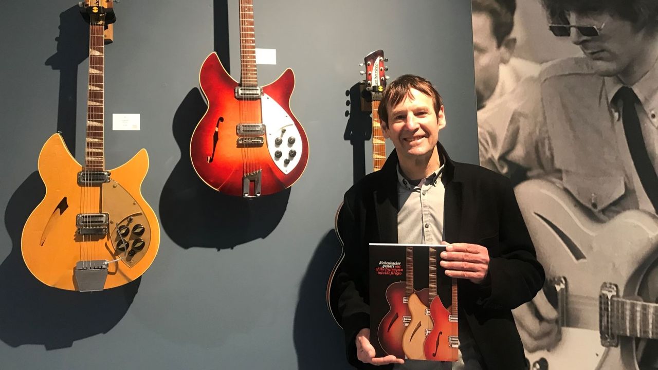 Dave Greogry holding his copy of 'Rickenbacker Guitars: Out of the Frying Pan Into the Fireglo' at Shapiro Rare Books' 2022 Rickenbacker exhibition in London