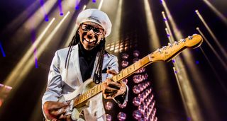 Nile Rodgers plays his hitmaker Stratocaster under the stage lights at the Ziggo Dome, Amsterdam