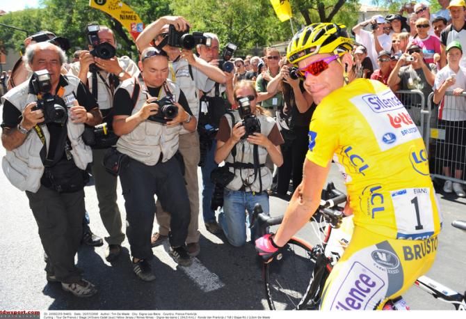 Wearing the number one dossard, Cadel Evans poses for the cameras in the yellow jersey
