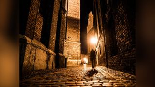 A creepy shadow in a dark alley meant to represent Jack the Ripper.