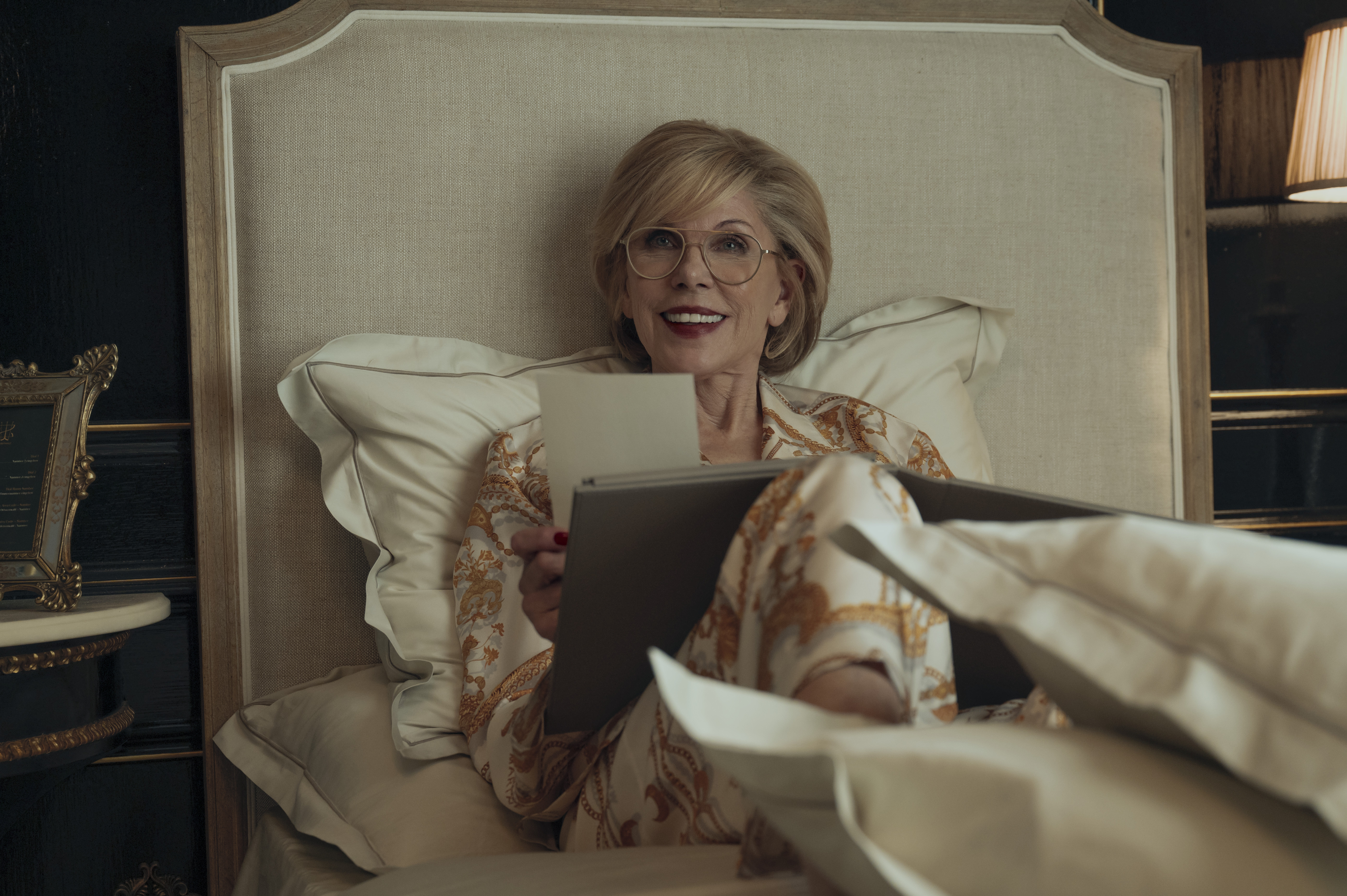 christine baranski as victoria laying in bed in stain pajamas in nine perfect strangers season 2