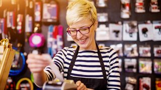 woman using a pos system card reader in a store