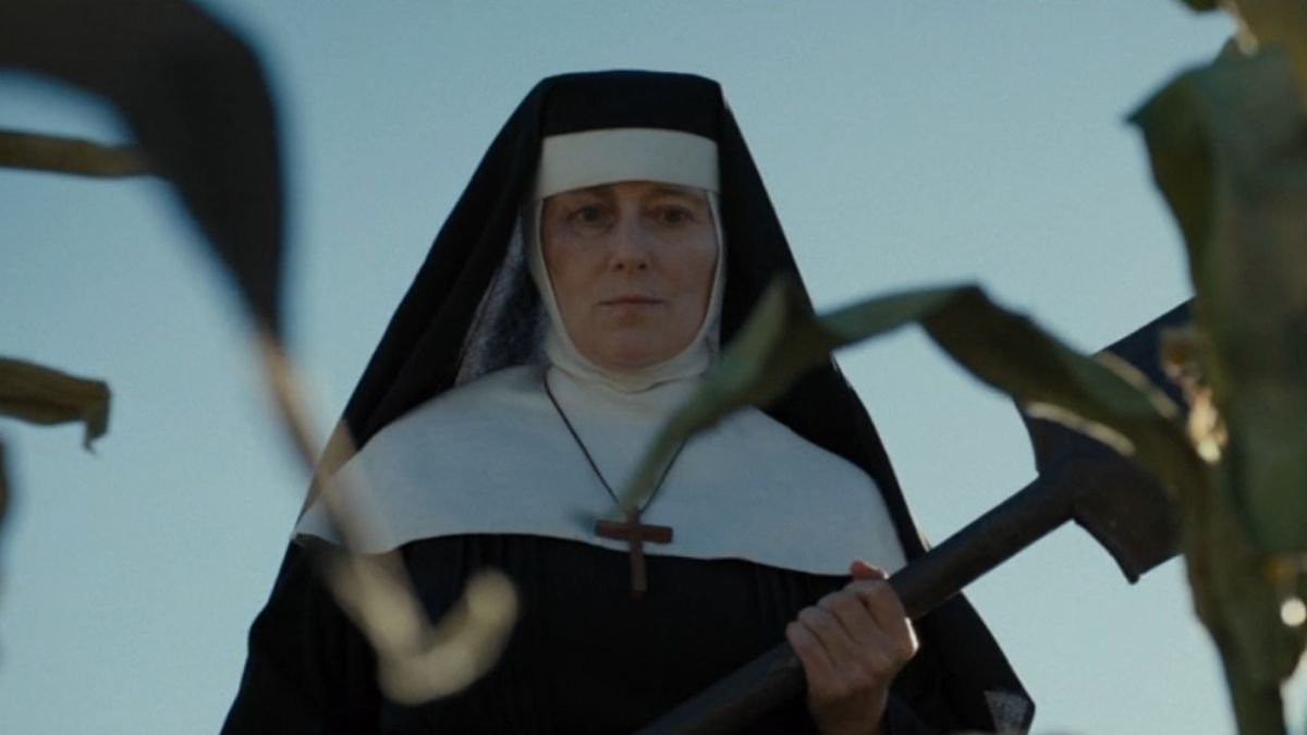 Sister Mary holding shovel in corn field in 1923