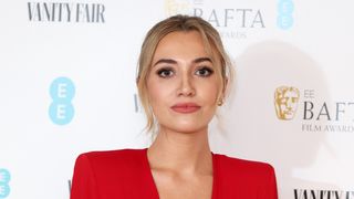 Tilly Keeper in a red dress at the EE British Academy Film Awards 2023