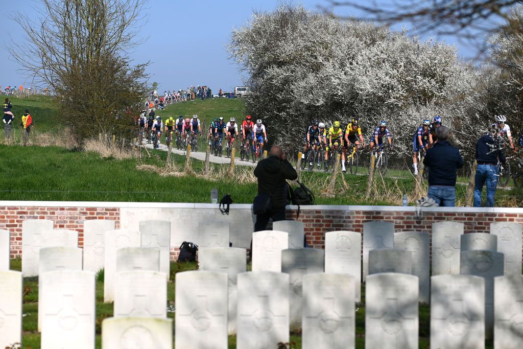 WEVELGEM BELGIUM MARCH 27 A general view of the peloton passing through the Graveyard Plugstreet zone during the 84th GentWevelgem in Flanders Fields 2022 Mens Elite a 2488km one day race from Ypres to Wevelgem GWE22 WorldTour on March 27 2022 in Wevelgem Belgium Photo by Tim de WaeleGetty Images