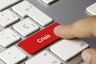 Man pressing red crisis key on keyboard