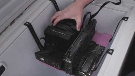 A photo showing PC hardware being installed into a freezer temporarily