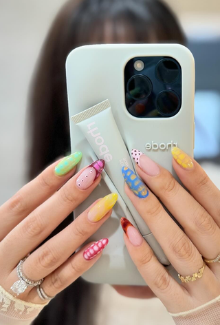 A manicure featuring mixed patterns by Zola Ganzorigt.