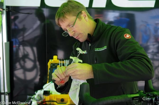 Cannondale team manager performing a delicate procedure prior to the race