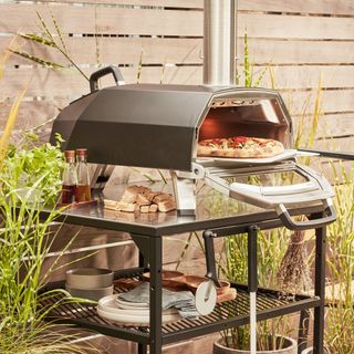 outdoor kitchen trolley with pizza baking machine and bottles