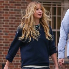 Jennifer Lawrence styled a navy sweater with her favorite skirt-pants and a Dior bowling bag
