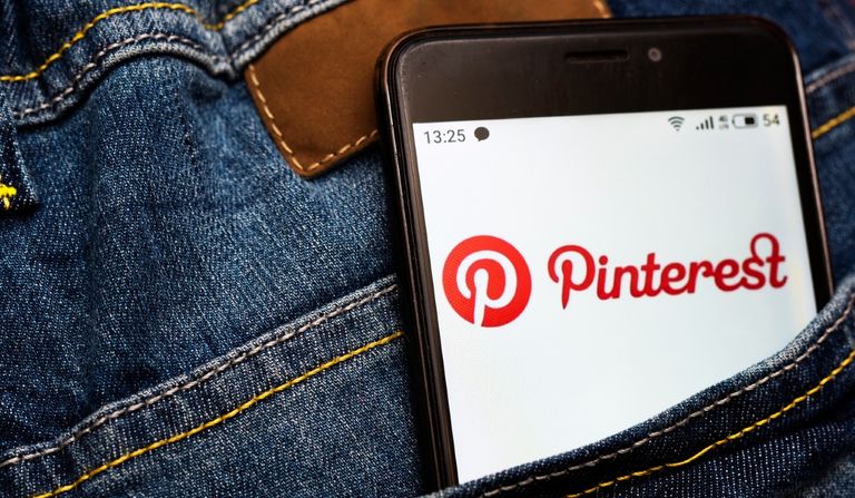 In this photo illustration a Pinterest social network logo seen displayed on a smartphone in a Jeans pocket.