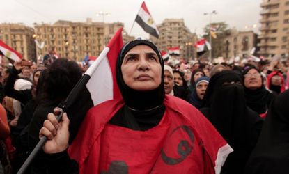 An Egyptian woman holds a national flag as she listens to speakers in Tahrir Square on Dec. 4.