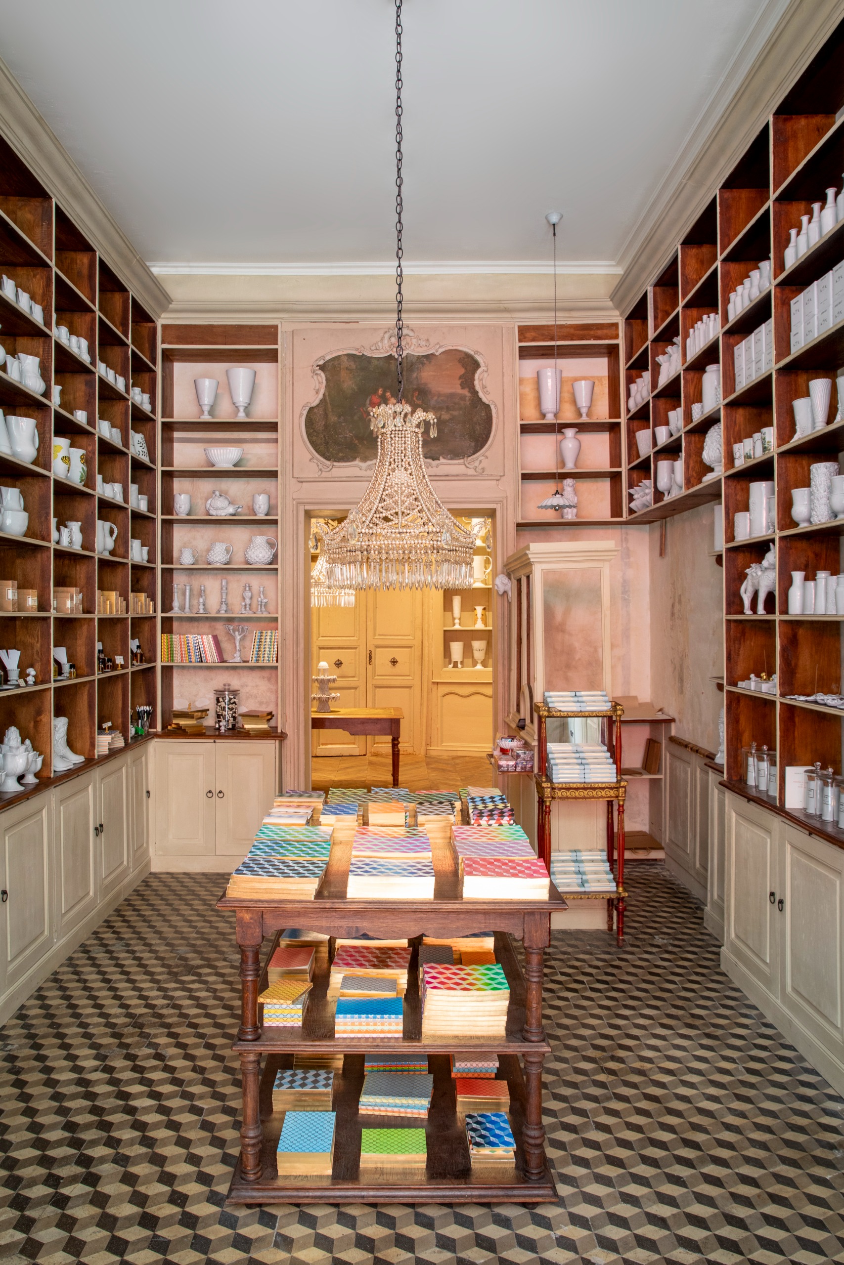 Interiors of an Art Deco-inspired parfumerie and stationery shops, with stacked-up wooden shelving, an earthy palette, and a stuck-in-time atmosphere with bespoke packaging.
