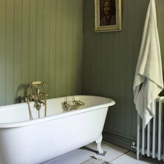 green bathroom with white free standing bath